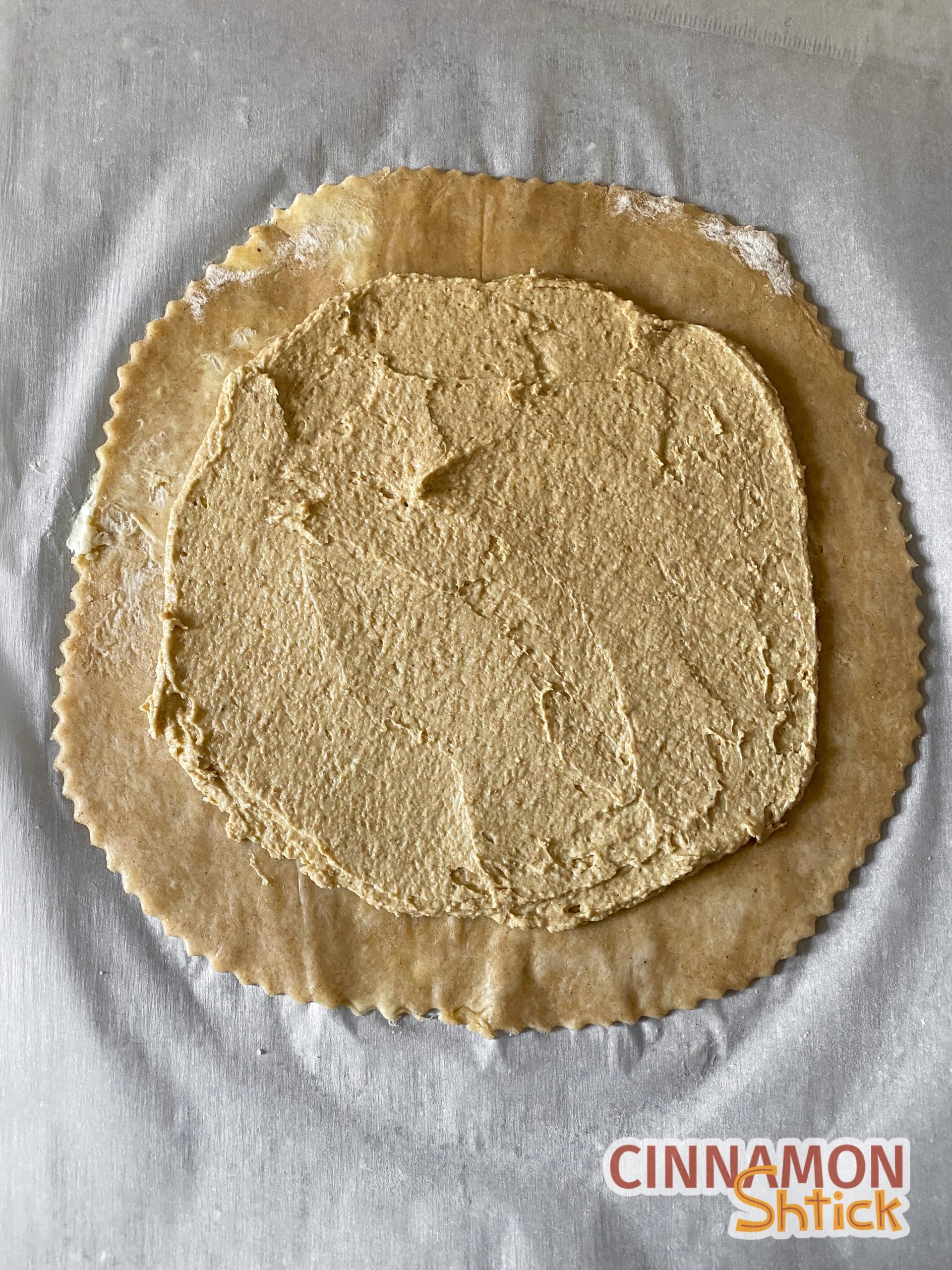 galette dough rolled to a disc with oatmeal cream spread on it