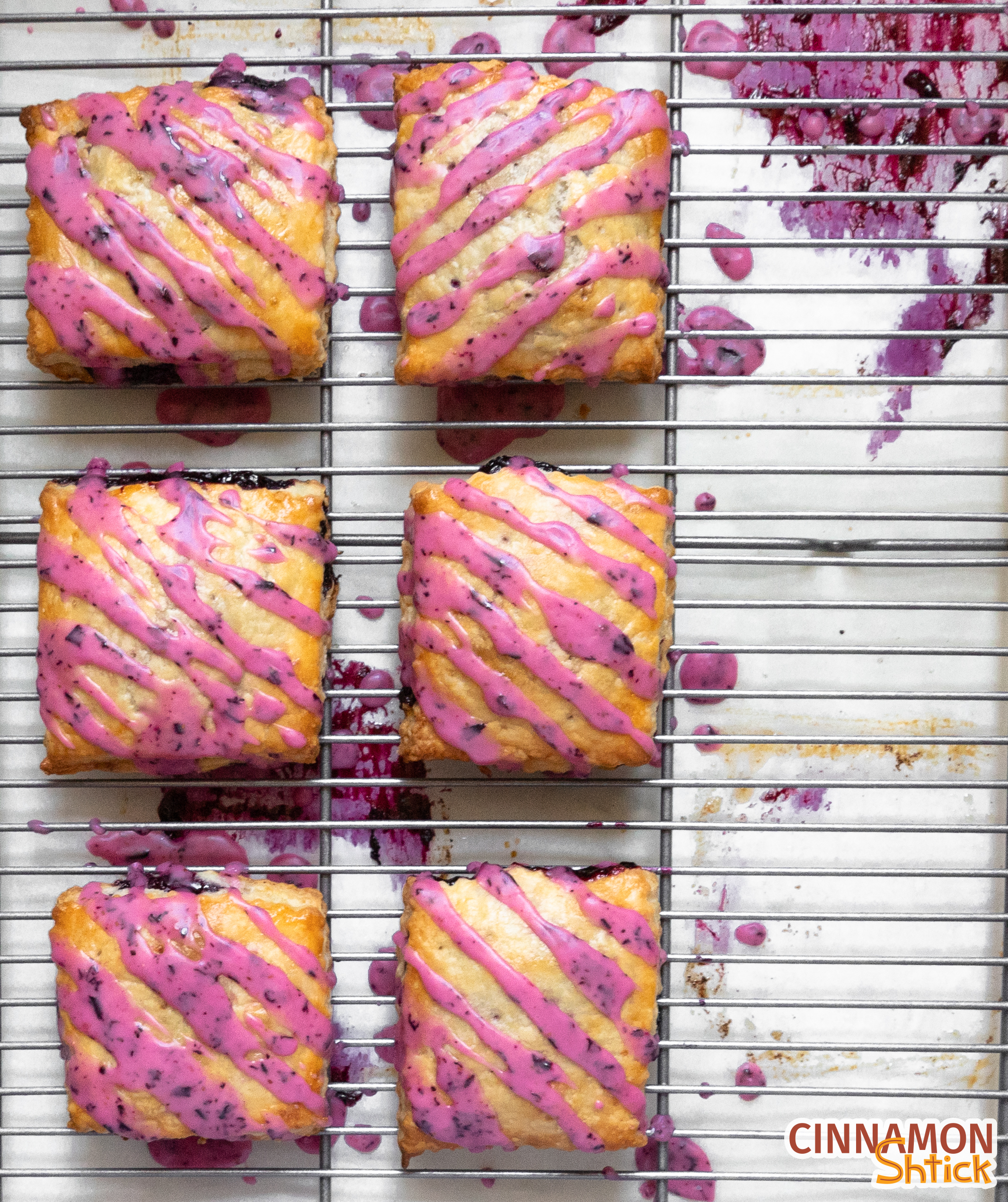 two columns of three Limoncello blueberry hand pies on cooling rack