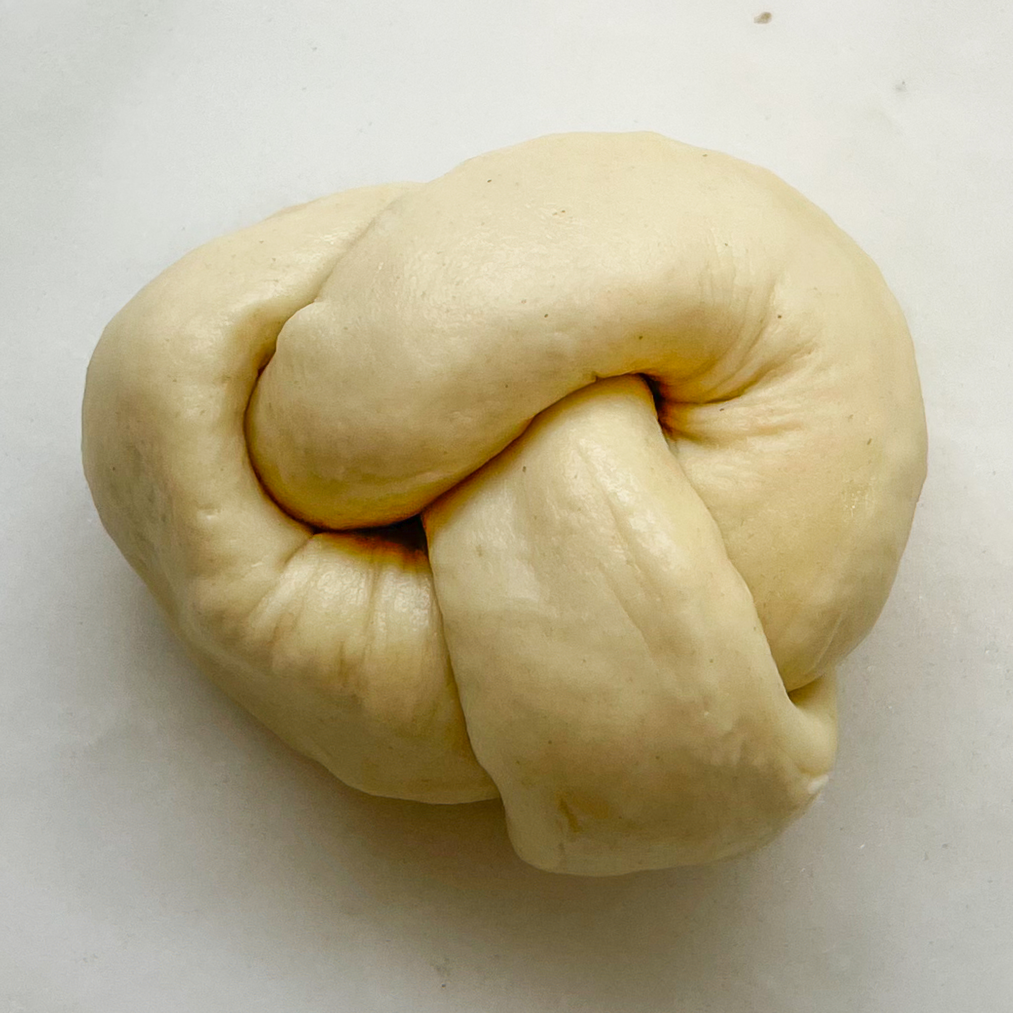 one sourdough discard garlic knot ready to be baked