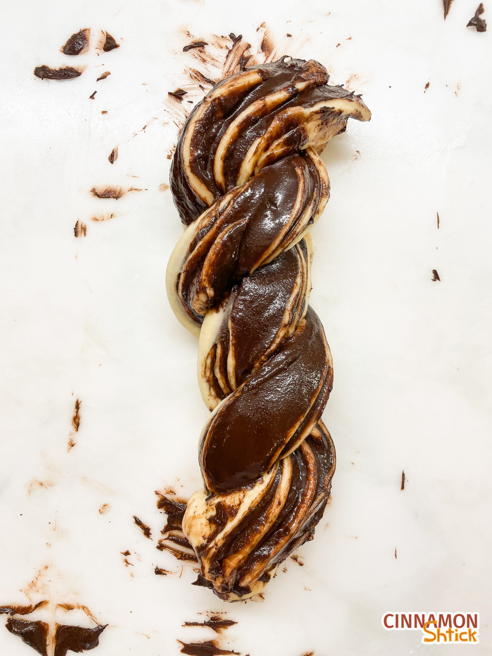 babka dough sliced and twisted showing the chocolate filling