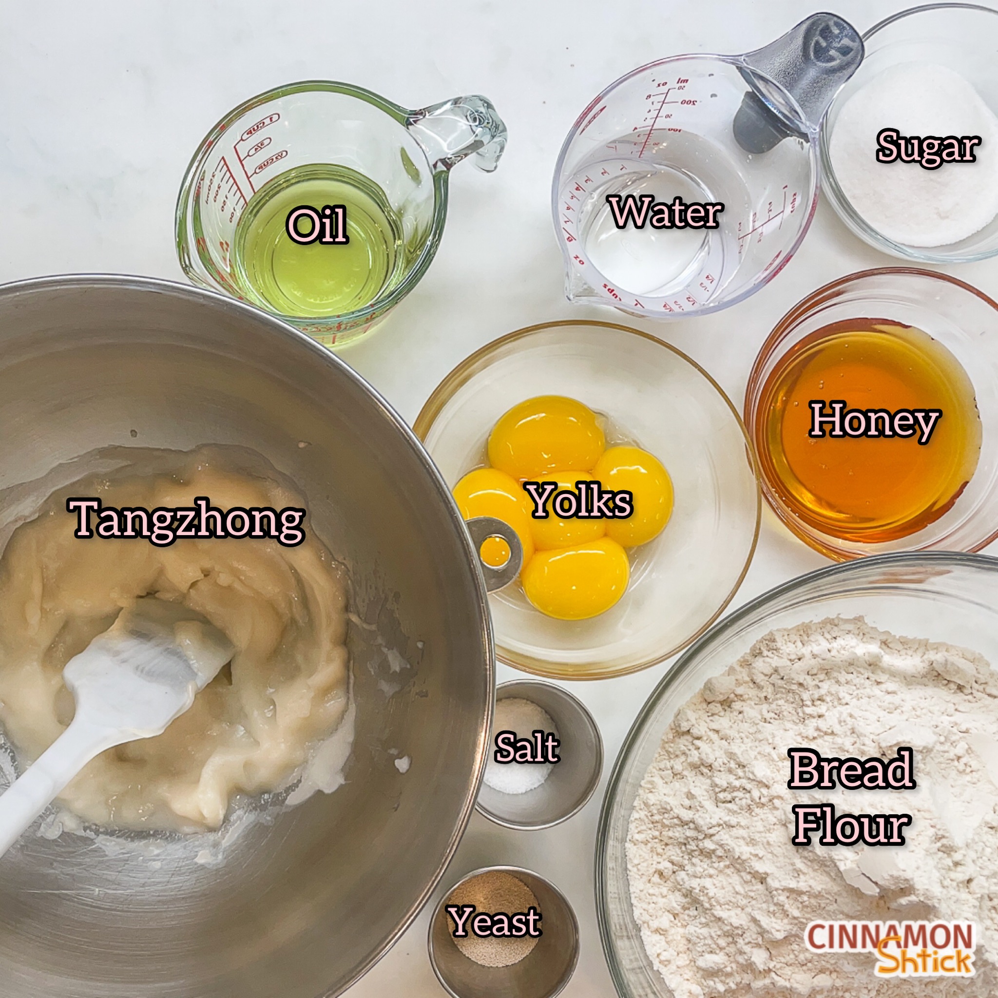 tangzhong in mixing bowl together with cups and bowls holding the rest of the challah ingredients, with each labeled as oil, water, sugar, honey, yolks, bread flour, salt and yeast