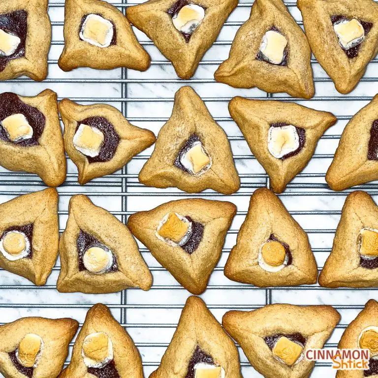 overhead view of s'mores brownie hamantaschen lined up on cooling rack