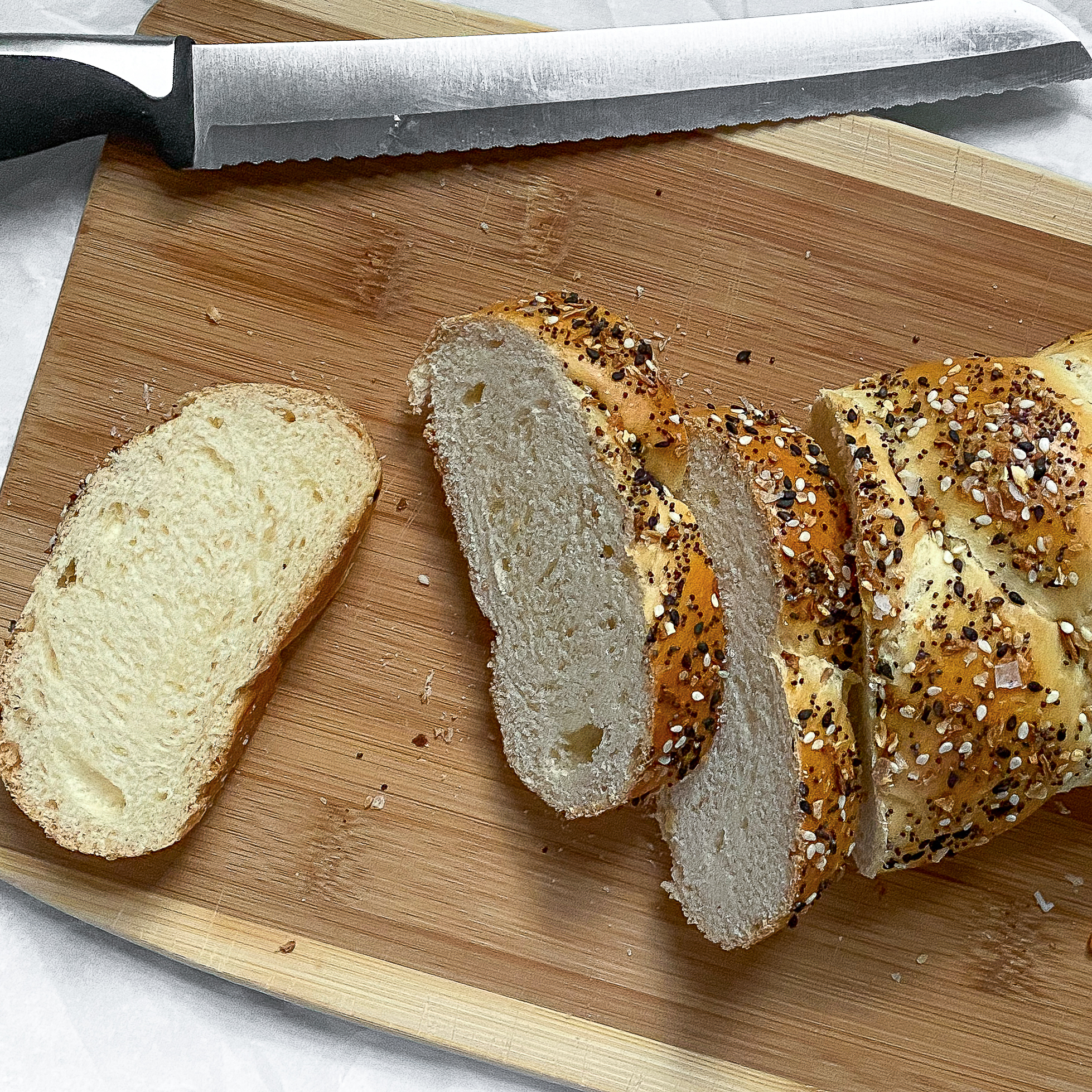 overhead view of challah sliced on a cutting board