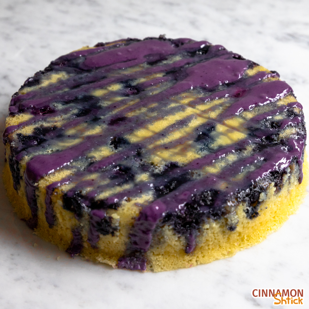 One layer lemon blueberry cake with blueberry glaze drizzled on top