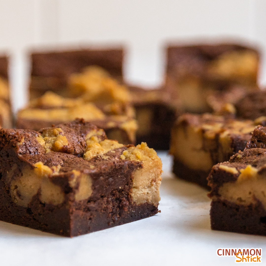 Close up of peanut butter cheesecake brownies spread on countertop