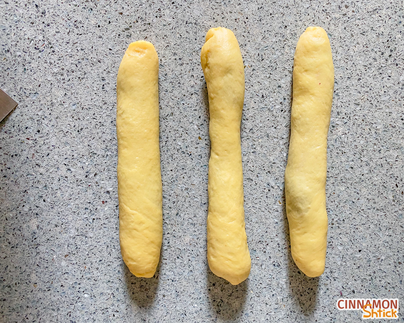 Three strands of dough, rolled up with the blueberry filling inside them.