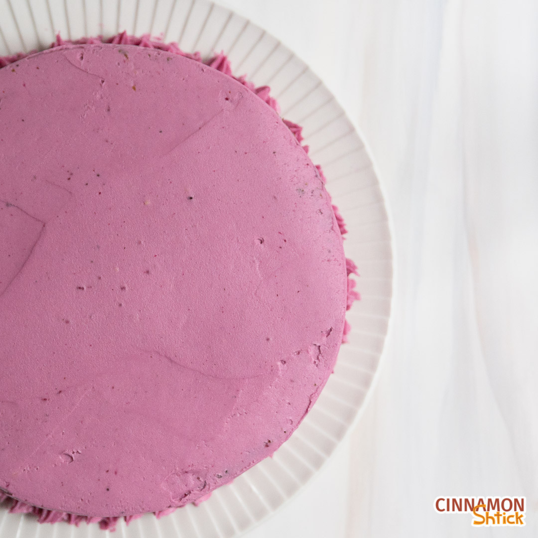 Top view of single layer spice cake with blueberry frosting