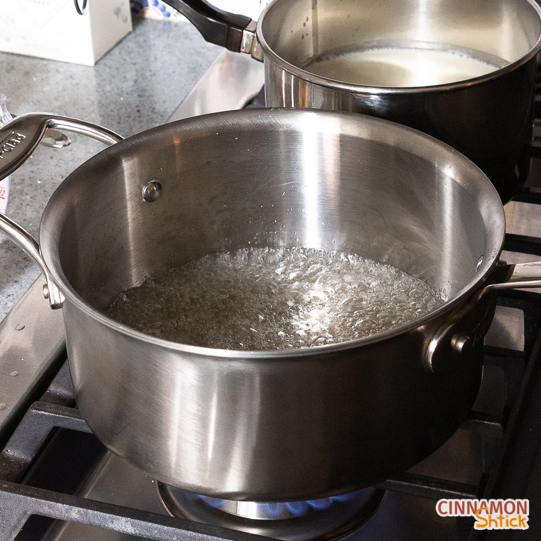 Sugar and water bubbling, with the sugar mostly vaporized, in pot.
