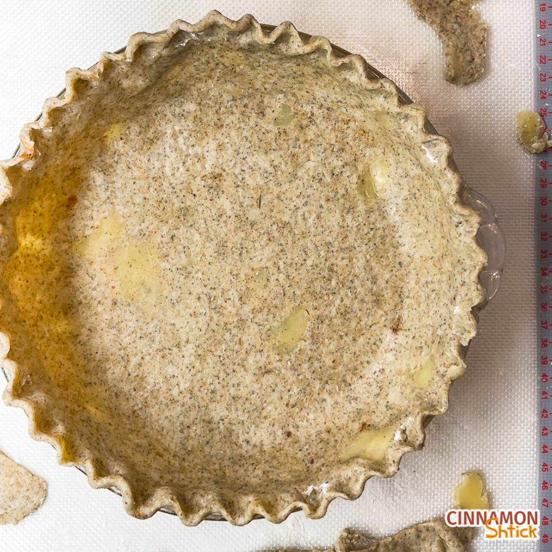 Brown butter rye pie dough crimped in a pie plate