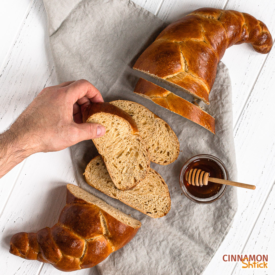 hand holding a slice of sourdough challah