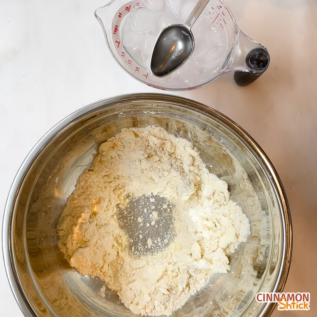 Bowl of butter/flour mixture with well in the middle of ice water