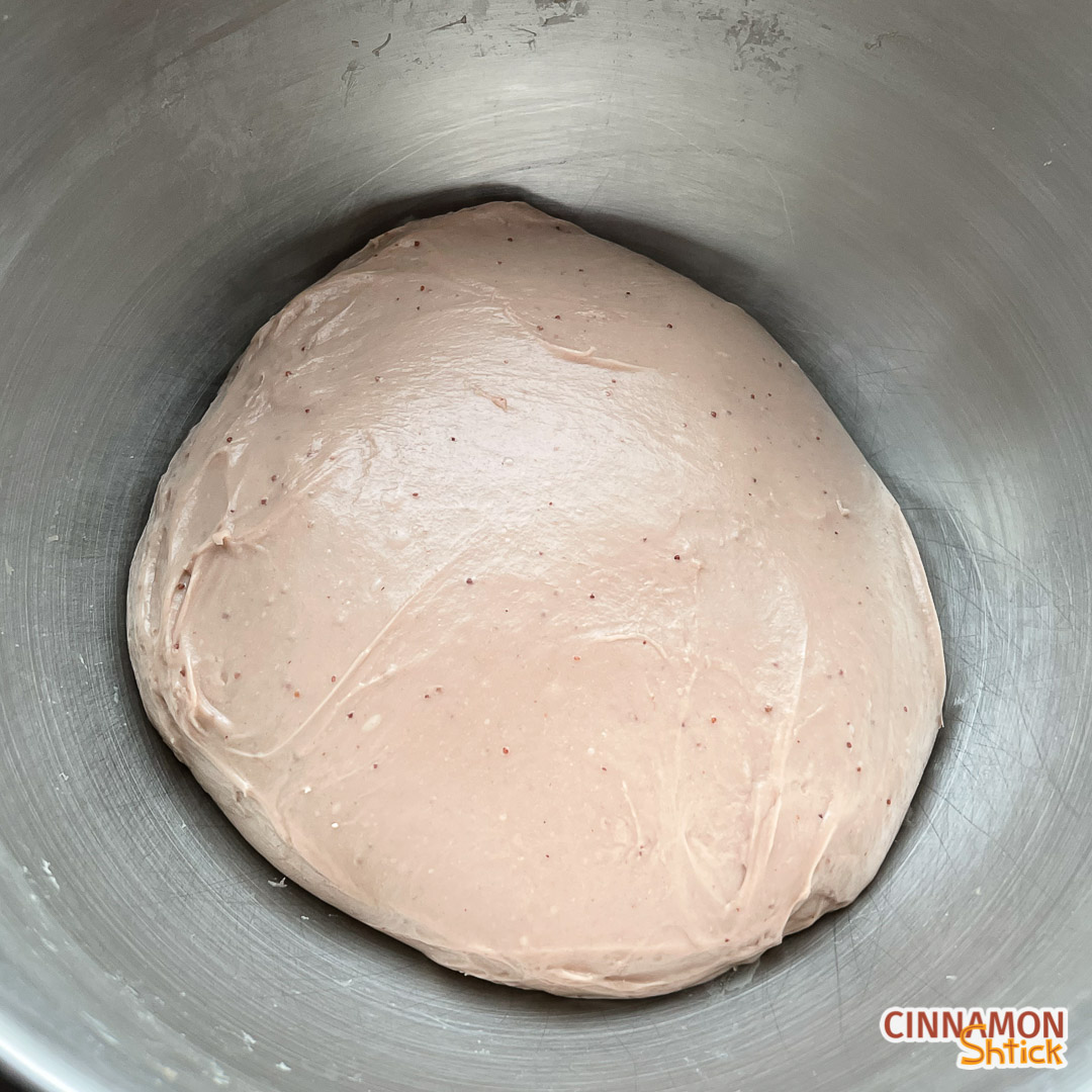 Ball of strawberry brioche dough in mixing bowl