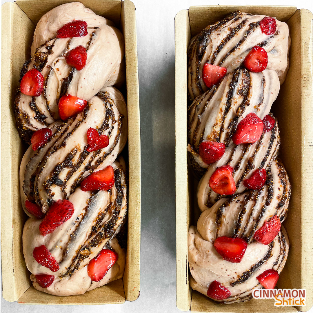 Two strawberry fig babka doughs with pieces of strawberries on top ready to go into the oven