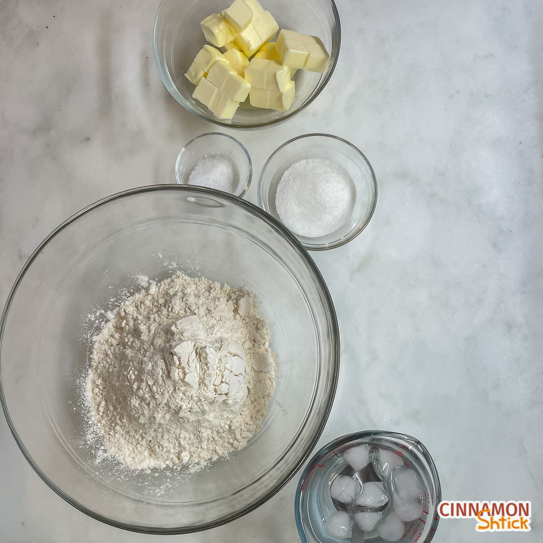 overhead view of galette dough ingredients: flour, butter, sugar, salt and ice water