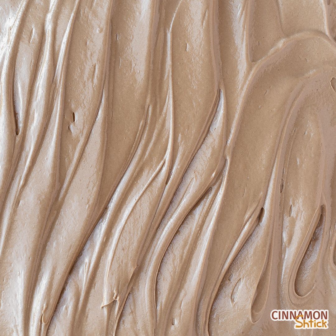 top view of milk chocolate frosting spread on cake