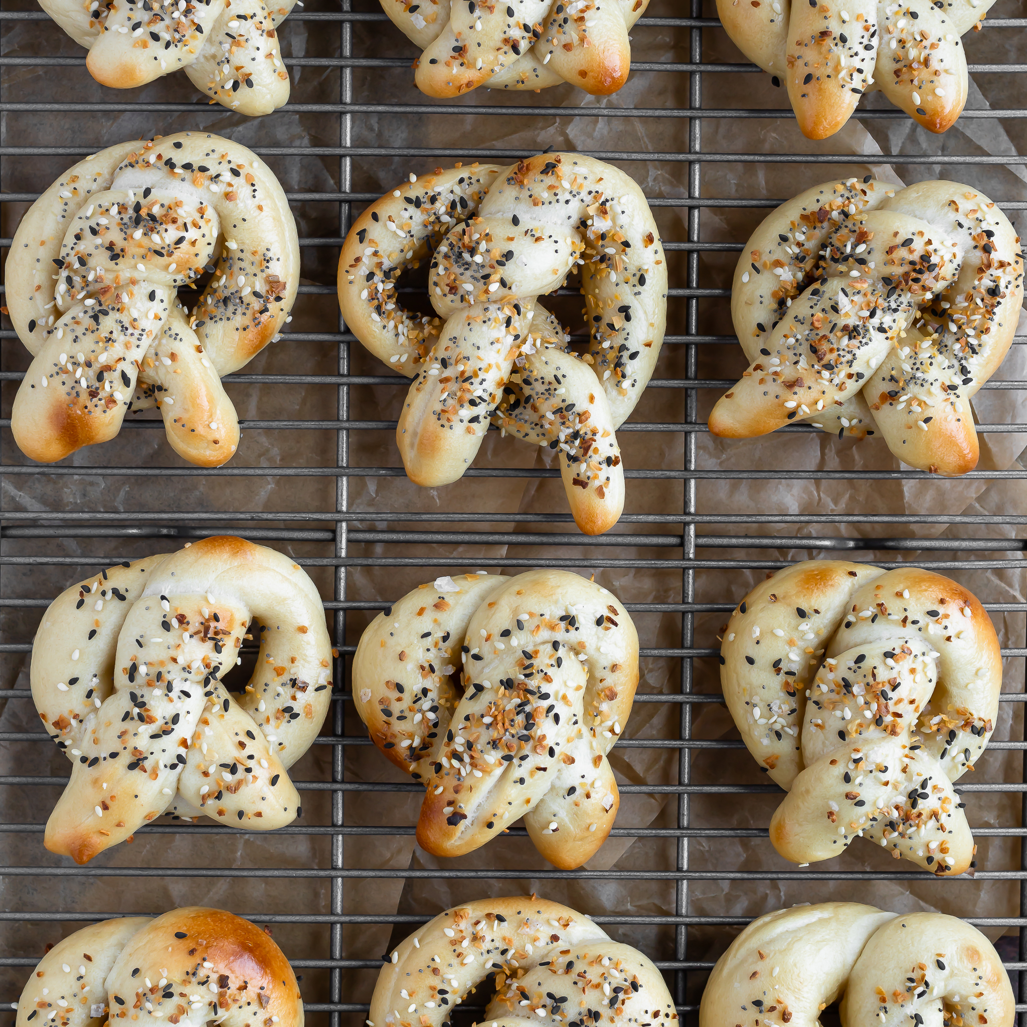 overhead view of 12 sourdough discard everything pretzels on a cooling rack