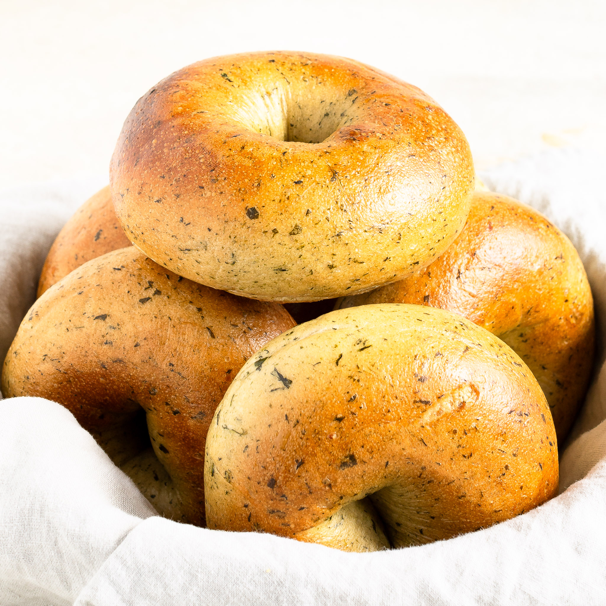 Spinach bagels in a bowl.