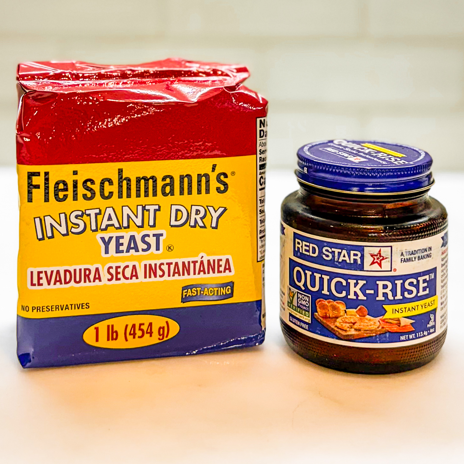 Block of Fleischmann's yeast on the left and a jar of Red Star rapid rise yeast on the right.