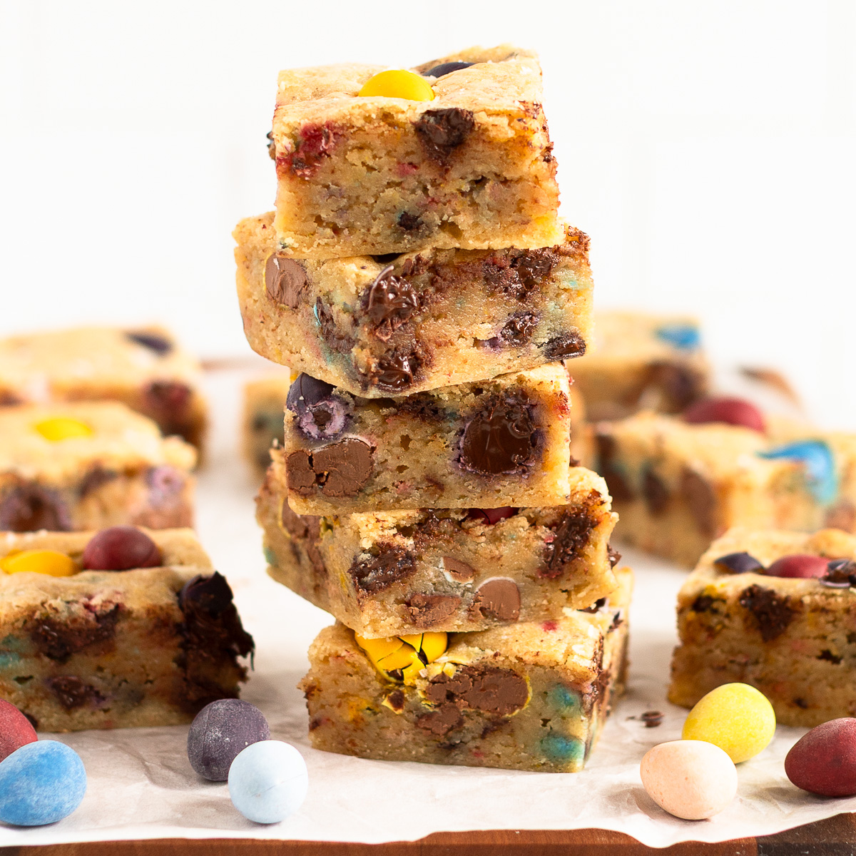 Stack of Easter sourdough blondies showing Cadbury mini eggs in the blondies and in the forefront.