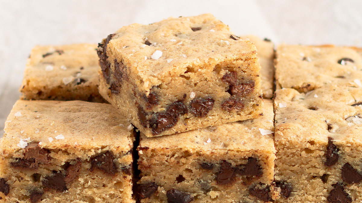 Close up of sourdough blondies cut in squares, showing the inside.