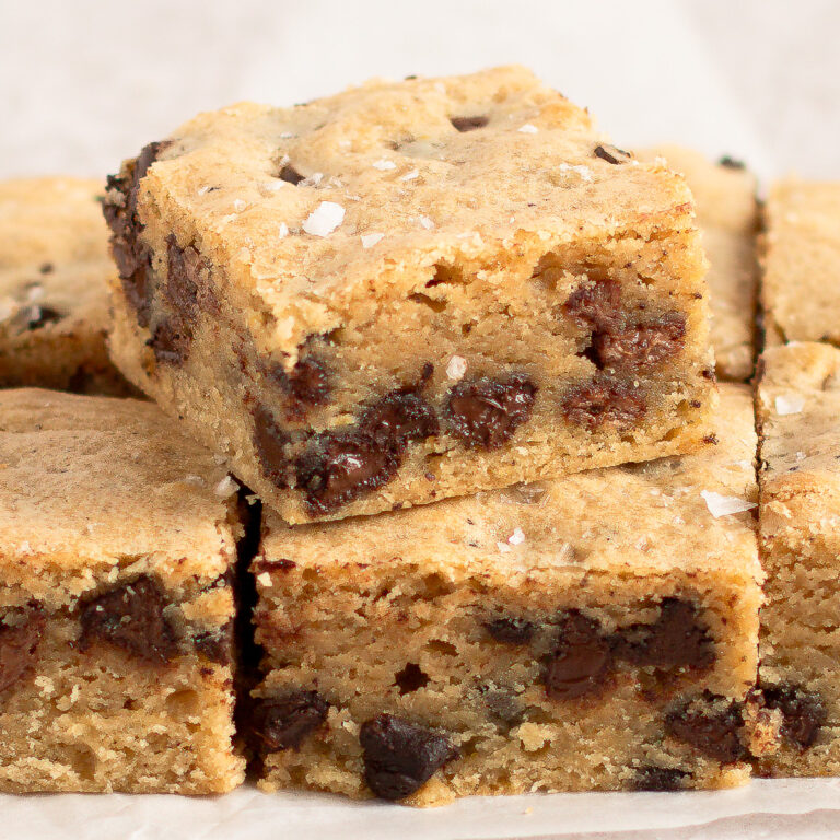 Close up of sourdough blondies cut in squares, showing the inside.